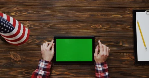View from the top on the woman's hands scrolling and taping on the black tablet Video stock 91723418