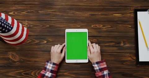 View from the top on the woman's hands scrolling and taping on the white tablet Stock-Footage 91724388