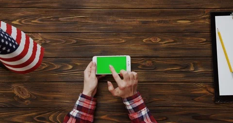 View from the top on the woman's hands scrolling and taping on the white Stock Footage 91724815