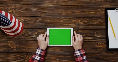 View from the top on the woman's hands scrolling and taping on the white tablet Stock Footage 91725310