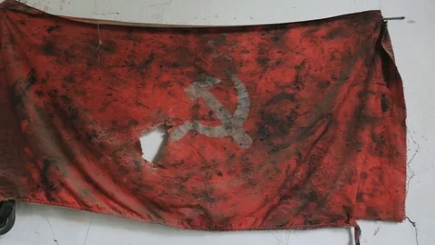 A view of torn and dirty red flag with a hammer and sickle Stock Footage 85297669