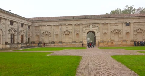 View of tourists at courtyard exploring Palazzo del Te in Mantua, Italy on a Stock Footage 297879218