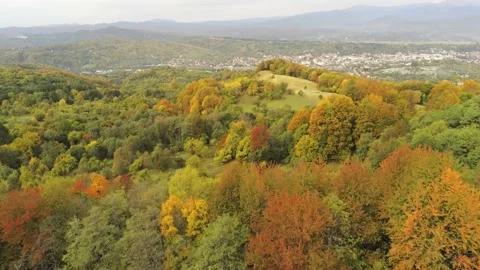 View towards the city in the valley between the mountains covered by autumn c Video stock 157843055