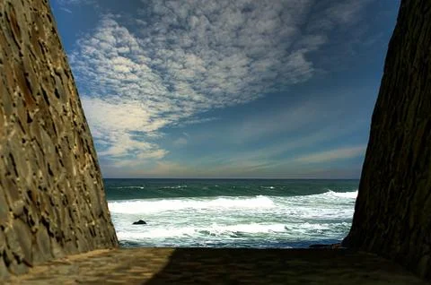 View towards the ocean from a corridor Stock Photos