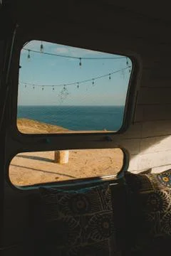 View towards the ocean from the inside of a camper van on a sunny day in Mexi Stock Photos