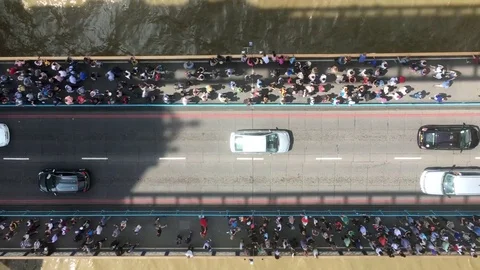 View from the Tower Bridge of pedestrians and cars crossing below Stock Footage 76966019