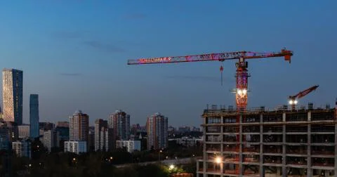 View of the tower crane on the construction site against the evening sky Stock Photos