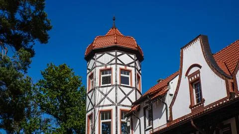 View of the Town Hall tower with a tiled roof. The brickwork of the building Stock Photos
