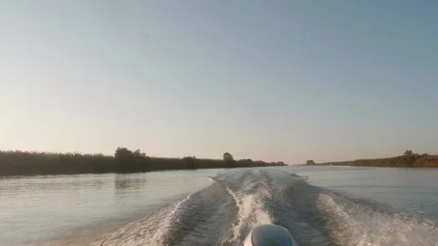 View of trace on river water left by motor boat while sailing. soft evening Stock Footage 124308243