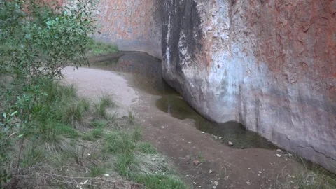 View on trace from waterfall on Ayers Rock (Uluru) monolith, Australia Stock Footage 278097652