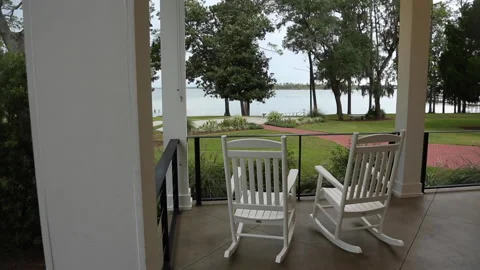 View Tracking Behind White Rocking Chairs On Porch Wide Shot 스톡 동영상 167738769