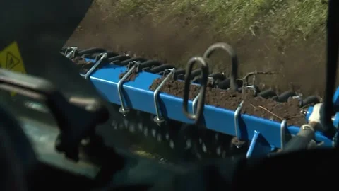 The view from the tractor cab. large plough harrow green field Stock Footage 130269250