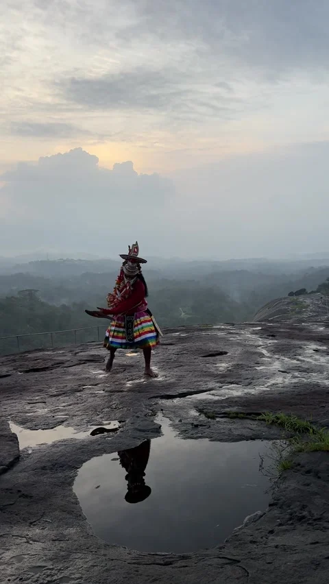 View of a traditional dancer performing on a rocky hill in Kochi, India. Video stock 334996672