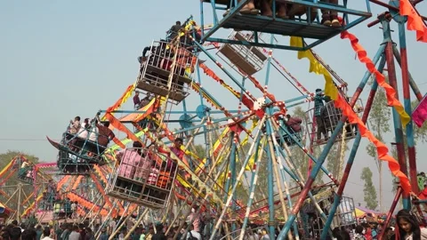 View of traditional Ferris wheels at a fair in Bangladesh. 스톡 동영상 335014643