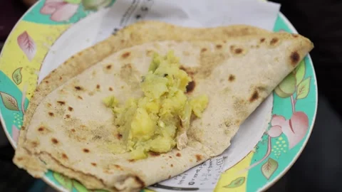 View of traditional flatbread and potato bhaji on a plate, Bangladesh. Stock Footage 335552266