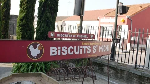 View of traditional sign "Biscuits St Michel" near bike rack at entrance of Stock Footage 150475862