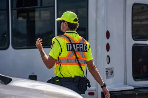 View of traffic control worker directing vehicles. Niagara Falls, Canada - July Stock Photos