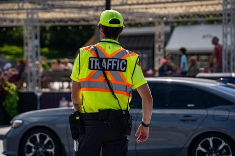 View of traffic control worker directing vehicles. Niagara Falls, Canada - July Stock Photos