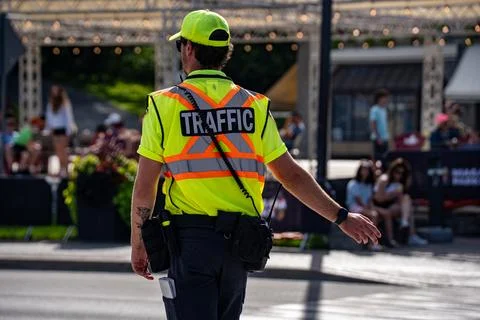 View of traffic control worker directing vehicles. Niagara Falls, Canada - July Stock Photos