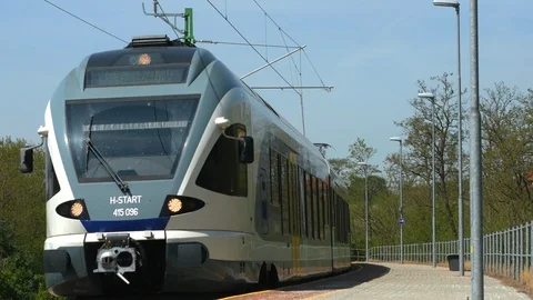 View on the train arrives at the station in Vecses, Hungary on a sunny day. Stock Footage 106104384