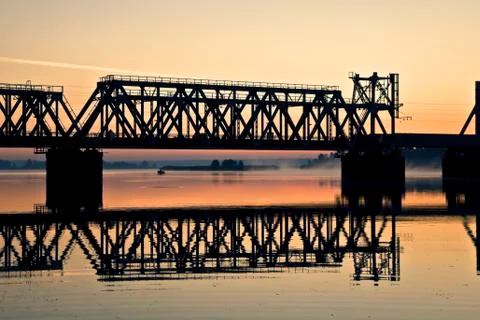 The view on train bridge above the river during sunrise. Photos