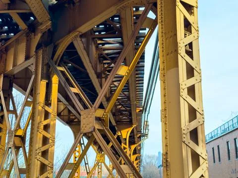 View of a train bridge structure from below with metal beams and supports, .. Stock Photos
