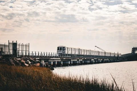 View of A train crossing the bridge over Jamaica Bay in the Queens, New York Stock Photos