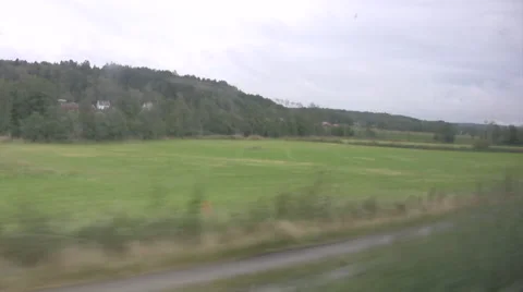 View from a train looking out onto green countryside in Sweden Video stock 56284779
