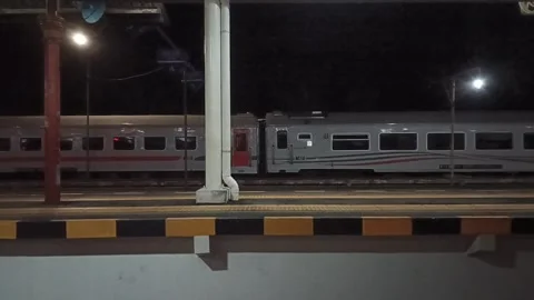 View of a train station at night, seen from the window of a train that has just  Stock Footage 312863246