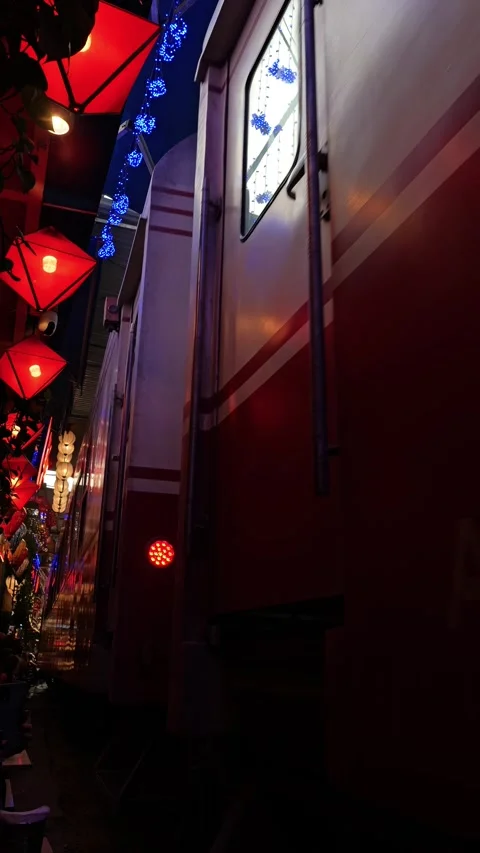 View of Train Street with red lanterns and passing train, Vietnam. Stock-Footage 343879106