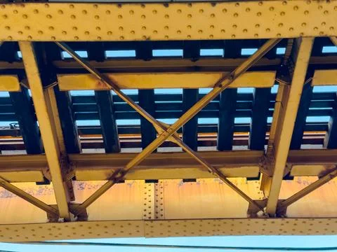 View of train tracks and structure from below in an urban area during the d.. Stock Photos