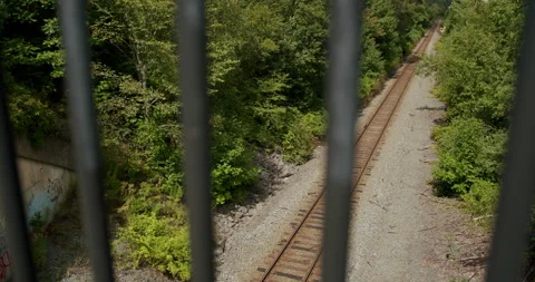 View of train tracks through bridge near Dewolf park Stock Footage 205010435