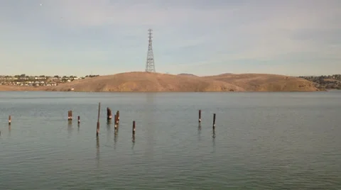 View from a train traveling along a river delta, passing an old dock Stock Footage 34211750