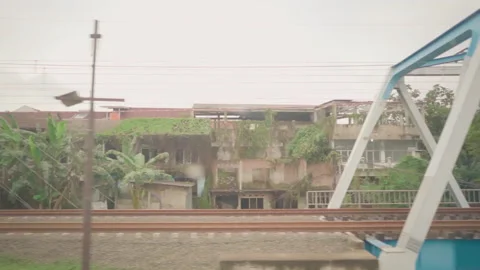 View from train window. Abandoned buildings. Motorcycle riders stopped Stock-Footage 248779146