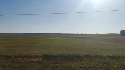 View from the train window of a beautiful landscape of fields and blue sky in 動画素材 296228036
