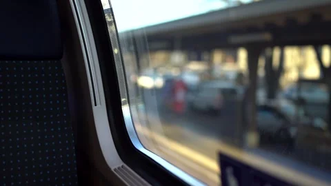 View from train window of departing train with blurry outside Stock Footage 263816347
