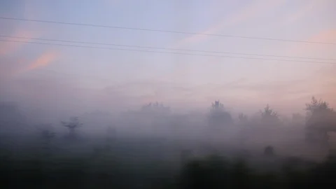 View from the train window - forest and valley in the fog, early morning before Stock Footage 89617762