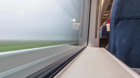 View from train window of green landscape moving past Video stock 333815753