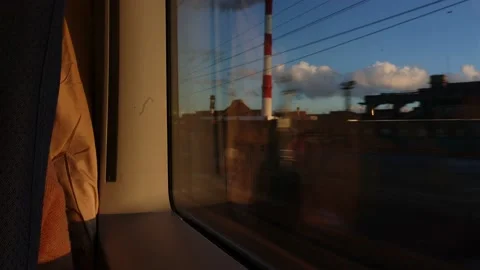 View from train window. High-speed train rushes in evening with sunbeams at Stock Footage 228219403