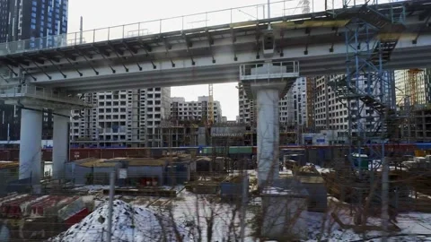 View from the train window of an industrial zone built up with residential bu Stock Footage 173553067