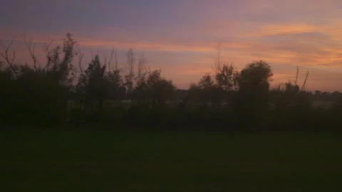 A view from the train window of an interesting landscape during sunset Stock Footage 253476998