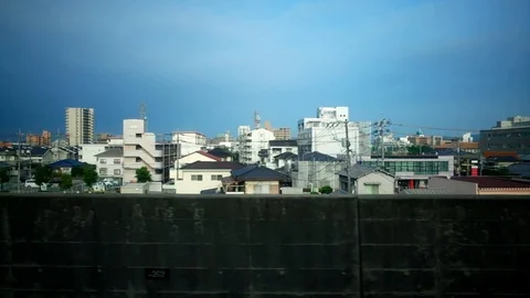 View from train window in Japan with urban scenery passing by Stock Footage 93666712