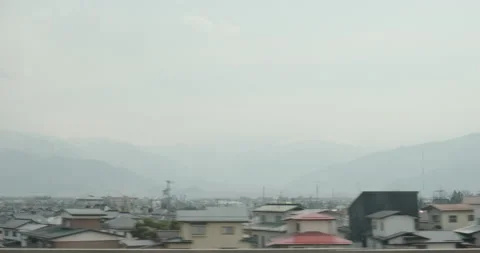 View from train window, Japan, urban landscape, mountains at backround. Beatiful Stock-Footage 133064441