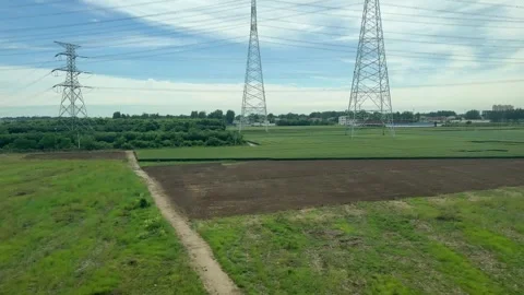 View from a train window looking at a green summer agriculture field Stock Footage 338095061