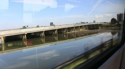 View from a train window passing bridge and water Stock Footage 37225084