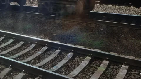 A view from a train window of a railroad siding with sleepers and a train Stock Footage 317812880