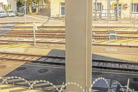 View from a train window of railroad tracks with a parking lot Stock Photos