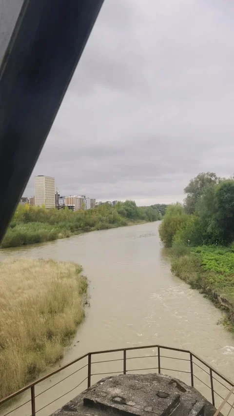 View from the train window of the river and the metal supports of the bridge 動画素材 299708891