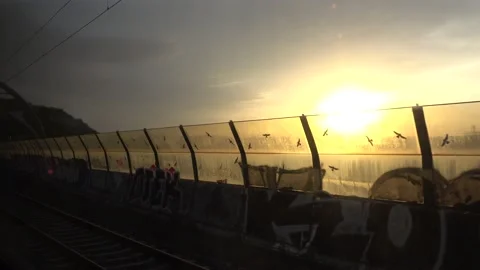 View From Train Window sunset, setting sun behind a glass barrier Video stock 158957556