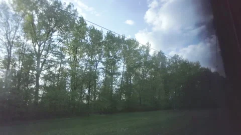 View from the train window, travel on a sunny day, trees outside the window Stock Footage 167432173